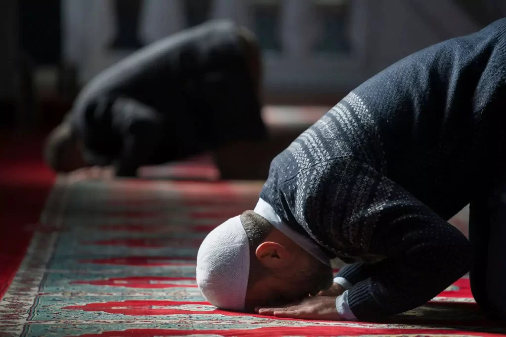 man praying in masjid 